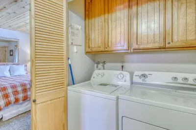 a laundry room with a washer and dryer and a bed at Snowpeak Chalet in Tahoe Donner in Truckee