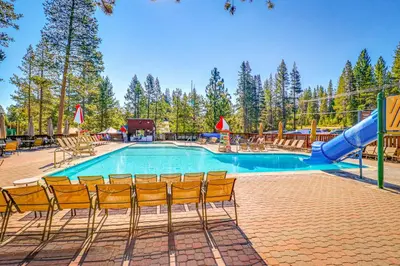 a swimming pool with chairs and a slide at Snowpeak Chalet in Tahoe Donner in Truckee