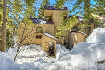 a house in the woods with snow around it at Carnelian Woods Sanctuary in Carnelian Bay