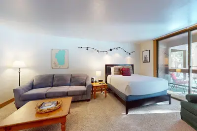 a living room with a bed and a couch at Aspen Grove Hideaway in Truckee