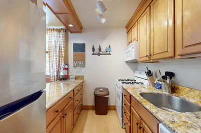 a kitchen with wooden cabinets and a sink at Aspen Grove Hideaway in Truckee