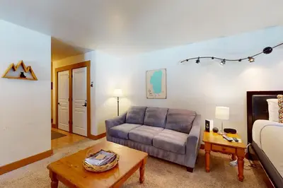 a living room with a couch and a bed at Aspen Grove Hideaway in Truckee