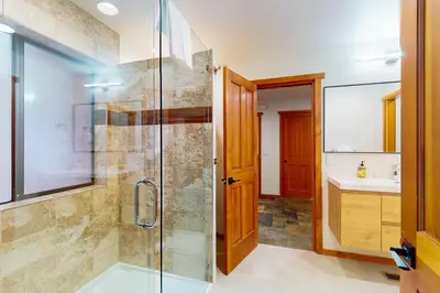 a bathroom with a glass shower and a sink at Sierra Solstice in Truckee