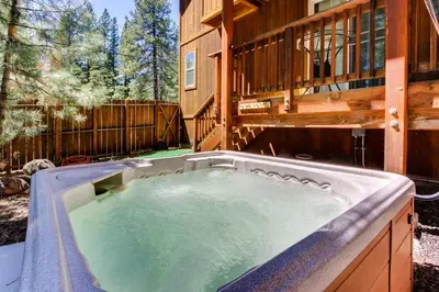 a hot tub in the backyard of a house at Wanderlust Cabin in Kings Beach