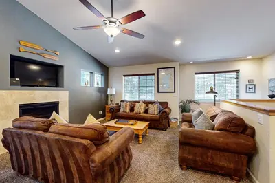 a living room with two couches and a fireplace at Wanderlust Cabin in Kings Beach