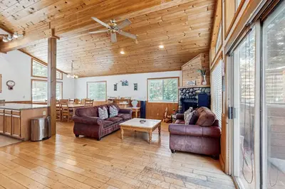 a living room with two couches and a table at Fawn Lodge in Tahoe Vista