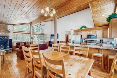 a kitchen and dining room with a table and chairs at Fawn Lodge in Tahoe Vista
