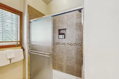 a shower with a glass door in a bathroom at Fawn Lodge in Tahoe Vista