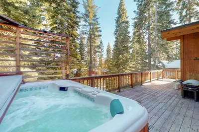 a hot tub on the deck of a cabin at Fawn Lodge in Tahoe Vista