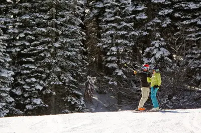 two people on skis in the snow next to trees at Northstar Original Village Studio One in Truckee