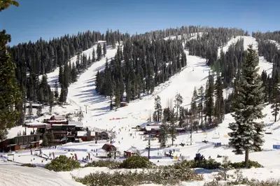 a ski slope with people skiing down a mountain at Northstar Original Village Studio One in Truckee