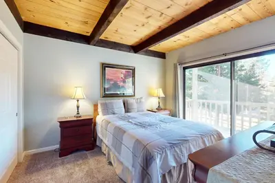a bedroom with a bed and a large window at Nordic Retreat in Kings Beach