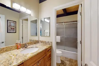 a bathroom with a sink and a toilet and a mirror at Nordic Retreat in Kings Beach