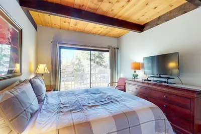 a bedroom with a bed and a flat screen tv at Nordic Retreat in Kings Beach
