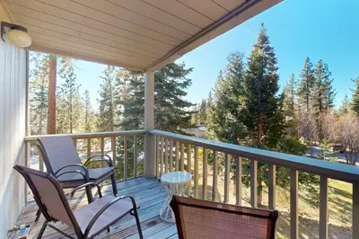 a screened porch with chairs and a table at Nordic Retreat in Kings Beach