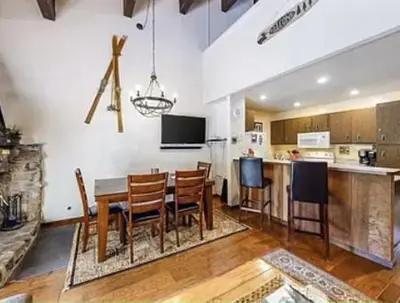 a kitchen and dining room with a table and chairs at Streamside Townhome in Kings Beach