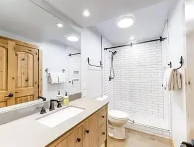 a bathroom with a toilet and a sink and a shower at Streamside Townhome in Kings Beach