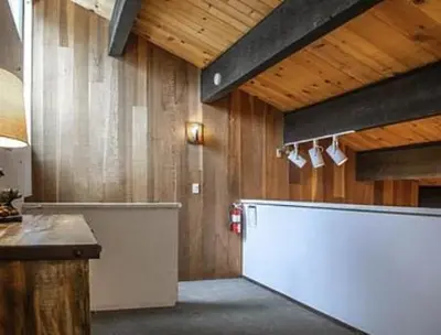 a kitchen with a large white counter and wooden walls at Streamside Townhome in Kings Beach