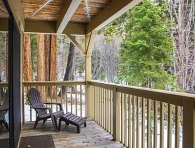 a screened in porch with two chairs on it at Streamside Townhome in Kings Beach