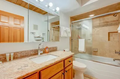 a bathroom with a sink and a shower and a toilet at Beaver Pond Northstar Luxury Chalet with Hot Tub in Truckee