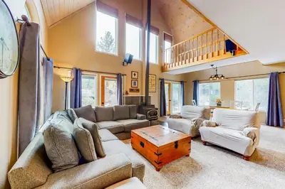 a living room with a couch and a table at Solvang Family Getaway in Truckee