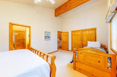 a bedroom with a bed and a dresser at Snowpeak Tahoe Donner Golf Course Views in Truckee