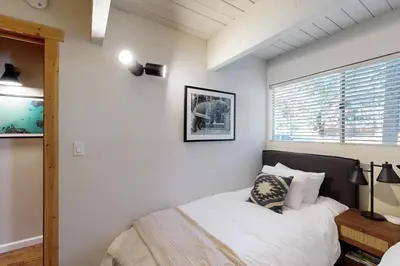a bedroom with a bed and a window at Canterbury Kings Beach Treehouse in Kings Beach