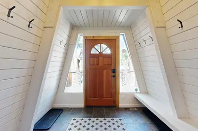 a hallway with a red door in a house at Canterbury Kings Beach Treehouse in Kings Beach