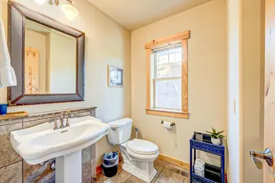 a bathroom with a sink and a toilet and a mirror at Stockholm Luxury Retreat in Truckee