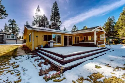 a yellow house with snow on the ground at Back Nine Bungalow in South Lake Tahoe