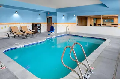 a large pool with blue water in a hotel room at Fairfield Inn & Suites by Marriott Hollister in Hollister
