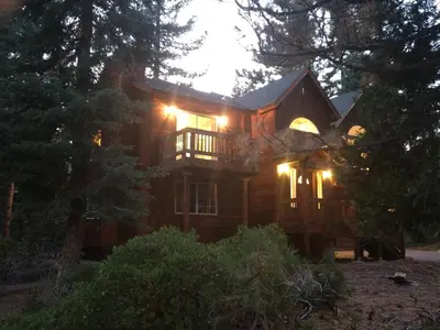 a large wooden house with lights on it at Kingswood Estate Cabin Retreat in Kings Beach