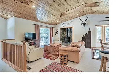 a living room with two chairs and a tv at Kingswood Estate Cabin Retreat in Kings Beach