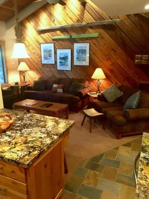 a living room with couches and a table at 114 Premium Condo in Mammoth Lakes