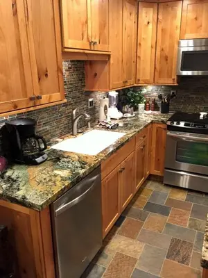 a kitchen with wooden cabinets and stainless steel appliances at 114 Premium Condo in Mammoth Lakes