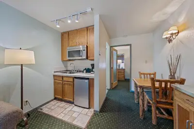 a kitchen and dining room with a table and a dining room at The Lodge at Lake Tahoe in South Lake Tahoe