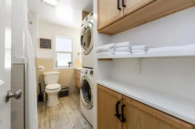 a bathroom with a toilet and a washer and dryer at Firelite Lodge in Tahoe Vista