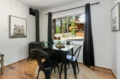 a dining room with a table and chairs and a window at Firelite Lodge in Tahoe Vista