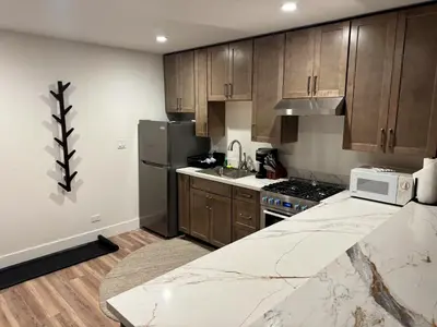 a kitchen with wooden cabinets and a marble counter top at Firelite Lodge in Tahoe Vista