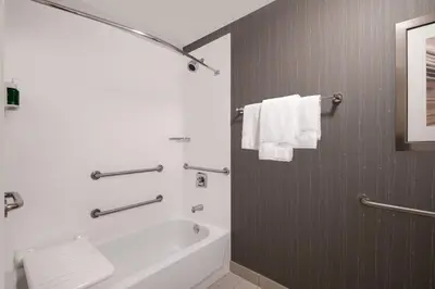 a white bathroom with a tub and a sink at Courtyard by Marriott Reno in Reno