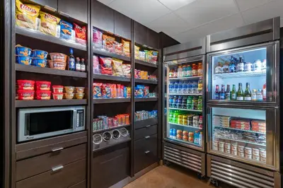 a kitchen with a refrigerator and a microwave at Courtyard by Marriott Reno in Reno