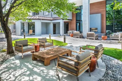 a patio with chairs and a wooden table at Courtyard by Marriott Reno in Reno