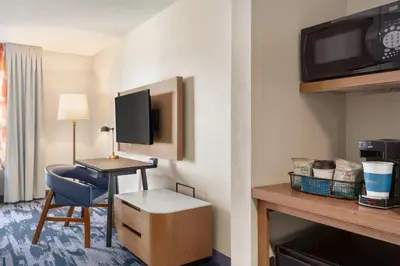 a hotel room with a desk with a chair and a tv at Fairfield Inn & Suites by Marriott Reno Sparks in Sparks