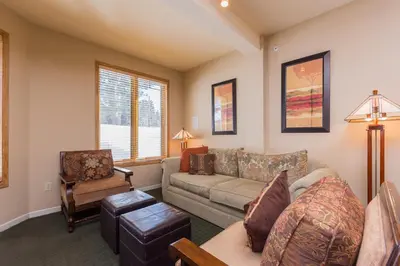 a living room with a couch and a chair at Mammoth Green # 105 in Mammoth Lakes