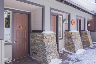 a front door of a house with two stone pillars at Mammoth Green # 105 in Mammoth Lakes