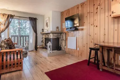 a living room with a fireplace and a tv at Mammoth View Villas # 34 in Mammoth Lakes
