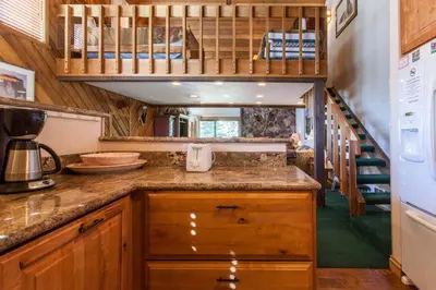 a kitchen with a counter top and a staircase at Snowcreek # 320 - Phase II in Mammoth Lakes