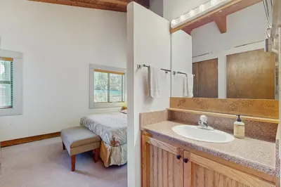 a bathroom with a sink and a bed at Silver Strike at Northstar in Kingswood Estates
