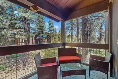 a screened in porch with a table and chairs at Silver Strike at Northstar in Kingswood Estates