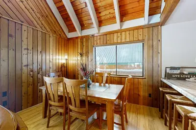 a dining room with a wooden table and chairs at The Hideaway in Meadow Lake Park